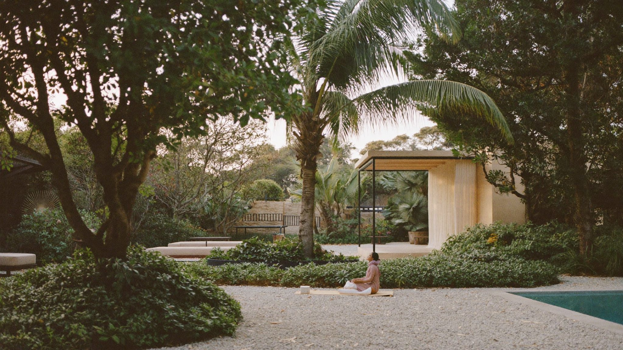 Guest stretching in the garden during a morning yoga session
